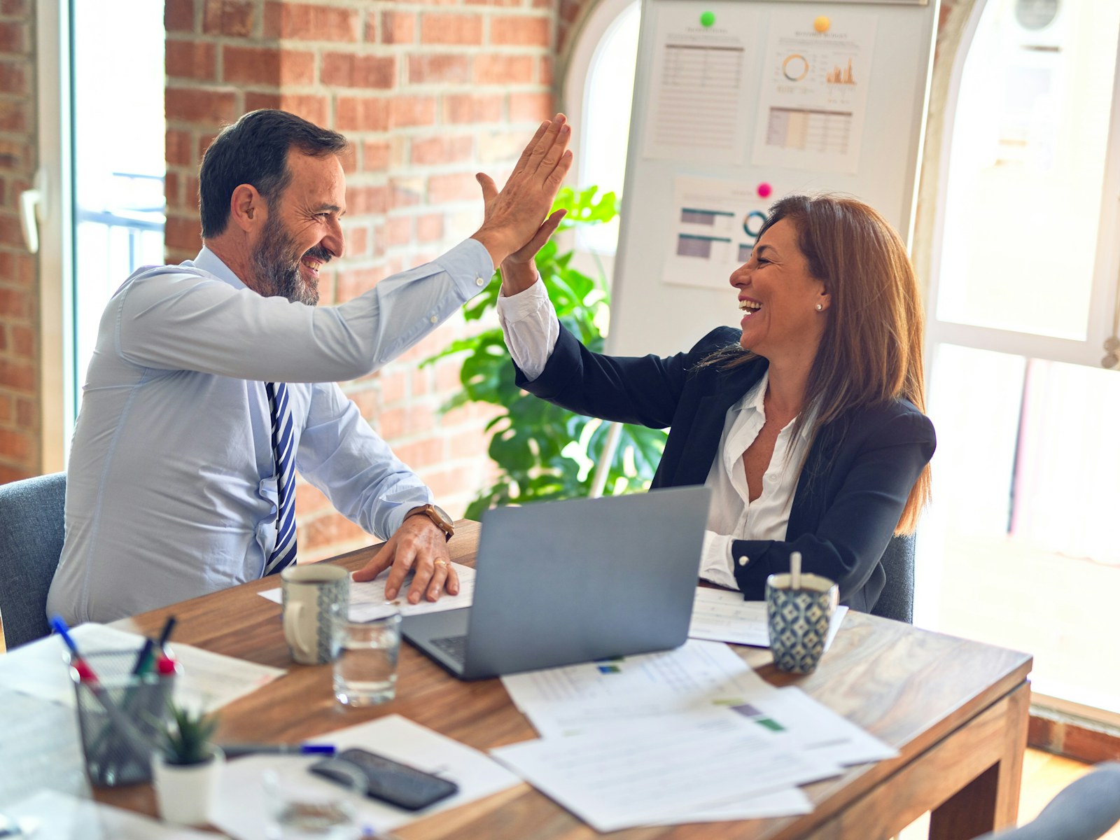 A marketing analyst and strategist reviewing campaign analytics together in AdsRoom
